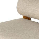Close view of rounded backrest cushion attached to wooden frame