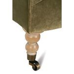 Close-up of rear left turned wooden leg with brass caster and smooth rounded finish