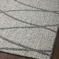 Close-up of Rainier Dove Grey Rug edge on wood floor highlighting subtle pile height and pattern detail