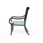 Side view of Monterey Dining Chair highlighting curved armrest and gently angled legs
