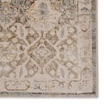 Close view of corner motifs displaying intricate faded gold and gray geometric pattern