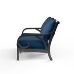 Side view highlighting Monterey Loveseat's curled armrest and profile of blue cushions on espresso frame
