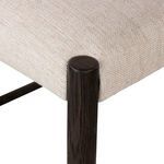 Detailed shot of seat corner showing upholstery wrapping and oak leg connection