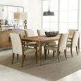 Dining room with eight Chapman Upholstered Chairs around rectangular wood dining table on woven textured rug