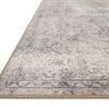 Corner view of Loren Silver / Slate Rug showing woven edge stitching and faint vintage motifs