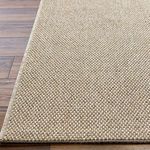 Top view close-up of Birdie rug edge highlighting tight weave and beige tonal fibers