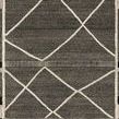 Hand-knotted Moroccan-style rug with beige linear and braided charcoal details and playful fringe