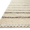 Angled view highlighting rug’s stitched edge and wool texture close-up