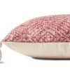 side view of pillow showing cream fabric backing and tassel detail