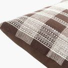 Close-up angle showing pillow’s woven plaid front and smooth solid dark brown fabric back