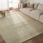 Rug in a living room setting under a beige sectional sofa, showing scale and integration with furniture