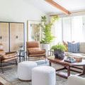 Bright living room with exposed beams and Atlas Marble Chain sculpture on dark wood round table