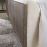 Close-up side angle of bed showing texture of Inverness Natural upholstery and rounded wood veneer panel