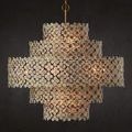 Lit chandelier with dark background enhancing silhouette and floral design