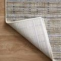 Bent corner flipped to show woven backing texture and construction of Soho Pebble Charcoal rug