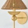 Perilla Wall Sconce with elongated gold frame, decorative sphere detail, and textured wicker rattan shade