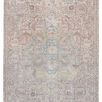 Traditional low-pile rug with a large light blue medallion center and tan, beige, gray vintage-inspired pattern