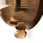 Close-up of rounded finial detail at bottom center of smoked glass chalice