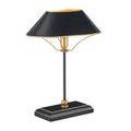 Elegant black table lamp standing on dark wood surface against white background