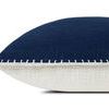 Side view showing navy front and textured white fabric on the back of pillow