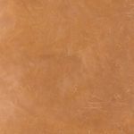 Close-up of tan leather cushion texture with natural creases and patina
