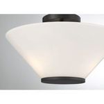 Blair semi-flush mount lit against a gray wall, highlighting soft diffused light