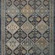Navy and blue vintage style rectangular rug with diamond and antique-inspired motifs in muted gold and cream