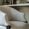 Tight front angle showing fabric texture and padded arm detail on Brewer upholstered dining chair