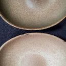 Close-up of two ceramic bowls emphasizing natural ceramic texture and glazing