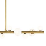 Lower angle close-up of chandelier’s natural brass bar with alabaster orbs clustered in varying sizes