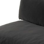 Detailed corner of sofa seat cushion and lower fabric skirt with visible stitching