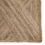 Close-up of braided edge and detailed jute weave texture in warm beige hues