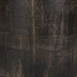 Close-up showing textured mottled distressed bronze finish on end table side
