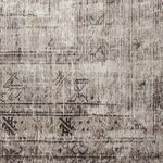 Detailed close-up showing faded floral and geometric designs with textured jute-blend weave
