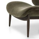 Close-up of tapered dark wood chair leg and lower frame beneath seat cushion