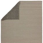 Corner of Ryker rug flipped showing detailed black and white patterned backing underlay