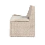 Side profile of outdoor banquette highlighting woven rattan frame and plush seat cushion