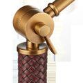 Detailed view of ratcheted joint with adjustment lever set against rust-colored woven faux leather handle