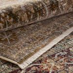 Rolled Zakaria rug showing textured pile and neutral fringe detail underneath