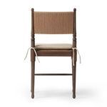Side profile of chair showing turned wood spindles and tied linen seat cushion