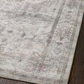 Close-up angled view of rug surface showing subtle medallion pattern and low pile texture