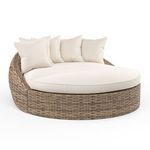 Havana Round Daybed with all-weather wicker in rich Aged Tobacco and plush cream cushions and pillows
