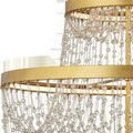Extreme close-up of gold rings detail and cascading strands of mixed-size clear glass beads