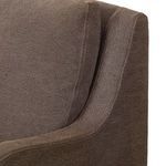 Close-up of armrest curve and linen cushion seam details