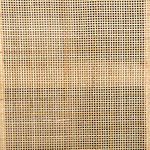 Detailed close-up of woven cane texture on cabinet door panel