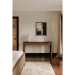 Dell table lamp positioned on a wooden console table in a minimalistic bedroom setting