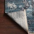 Back corner of Samra Dove / Sky Rug flipped to show detailed weave and solid cream backing with fringe