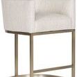 Side view showing angled backrest and metal base with curved front footrest of the brass stool