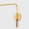 Close-up of the rattan-wrapped handle and aged brass wall mount of the sconce