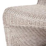 Close-up focused on front edge of seat displaying tight wicker weave detail